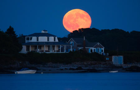 The full moon rises over Basket Island properties off of Hills Beach in Biddeford, Maine.