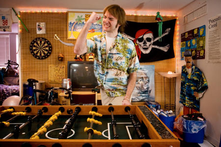 A Bowdoin College student celebrates a score while playing foosball in his dorm room. (Shot for US News & World Report Best Colleges Guide)