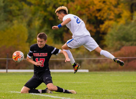 A Colby College soccer player gets air bound while making a shot during a Homecoming Weekend game against Wesleyan University on Colby's Waterville, Maine campus. (Shot for Colby College)