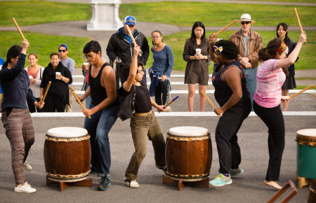 Colby College students engage in a Taiko drumming performance during Homecoming Weekend, on the steps of Miller Library on the Waterville, Maine campus. (Shot for Colby College)