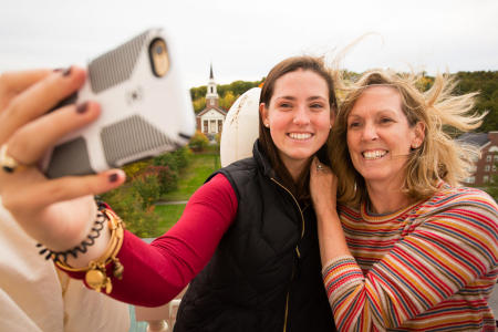 A Colby College student and her mother take a photo up on the Miller Library tower during Homecoming Weekend on the Waterville, Maine campus.(Shot for Colby College)