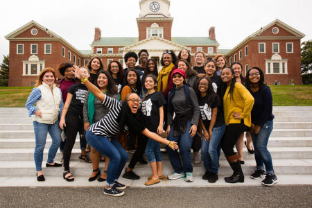 Colby College Alumni of Color Network members pose for a group portrait on the Miller Library steps during Homecoming Weekend on the Waterville, Maine Campus. (Shot for Colby College)