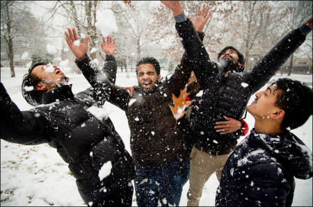 University of Southern Maine students from Nepal, the first time ever being in snow, joyously throw snow all over each other in Portland, Maine's Deering Oaks Park. Shot for The Portland Press Herald.