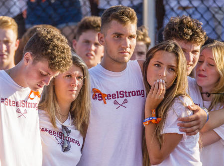 Friends and classmates of Freeport (Maine) High School lacrosse player Steel Crawford, solemnly listen in as Crawford is memorialized during a fund raising lacrosse tournament. Shot for The Portland Press Herald. 