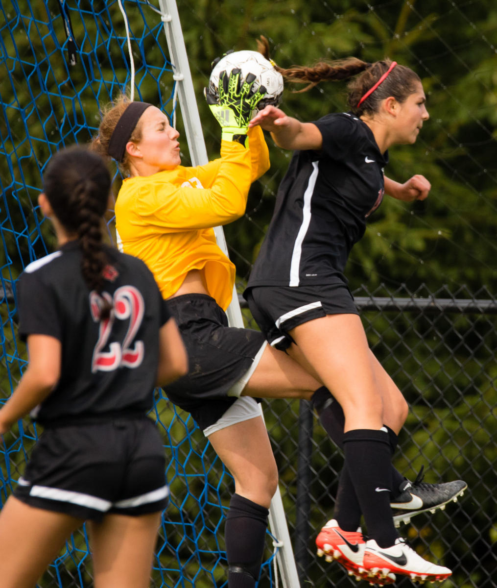 Colby College goalie makes a save during a Homecoming Weekend game against Wesleyan University on Colby's Waterville, Maine campus. (Shot for Colby College)