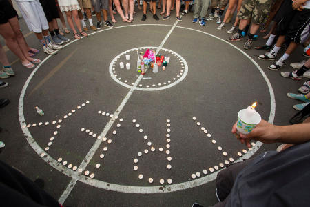 Mourners gather for a candlelight vigil for Treyjon Arsenault, 19, of Westbrook, at the town basketball courts where he frequently played. 