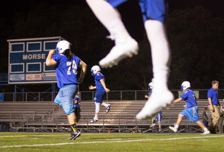 Morse High School football team members execute practice drills during Midnight Madness", the first football practice of the year for the Bath, Maine high school.