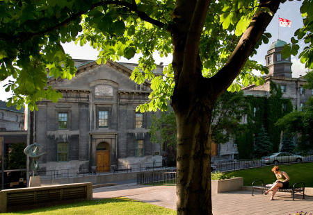 A student sits outside and reads on the campus of McGill University in Montreal during summer session. (Shot for US News & World Report Best Colleges Guide)