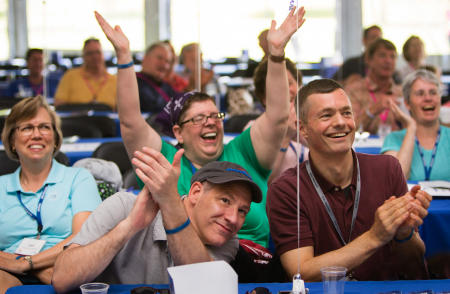 Colby College alumni cheer for classmates, who were presenting on stage, during a multi class reunion weekend on the Waterville, Maine campus. (Shot for Colby College)