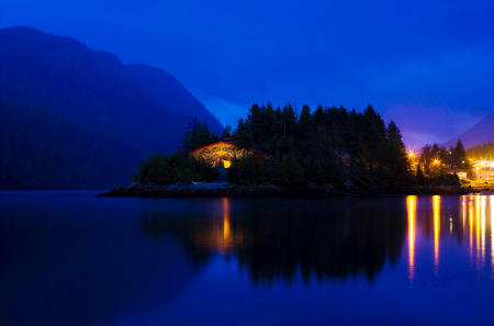 The "Big House", the traditional gathering place of the Kitasoo and Xai'xais people, is prominently positioned on the point of Swindle Island in the coastal fiords of British Columbia.