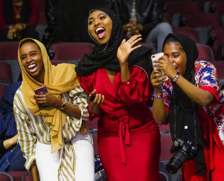 Sisters Hamdi Sheikh, Fardowsa Mohamed,and Aisha Mukhtar cheer for their sister Maryan Mukhtar who had just received a degree in Liberal Studies during the Southern Maine Community College commencement at Cross Insurance Arena in Portland, Maine. Shot for The Portland Press Herald.