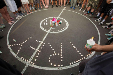 Mourners gather round a candlelight vigil for Treyjon Arsenault, 19 of Westbrook, on a public basketball court where he often played. Treyjon was caught in the crossfire of a gun conflict while at a Portland, Maine recording studio. Shot for The Portland Press Herald.