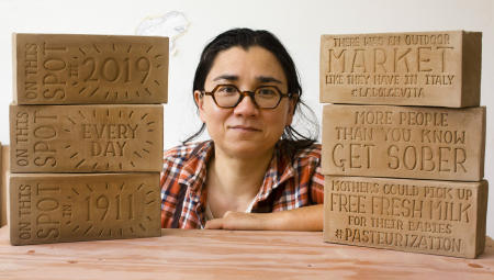 Artist Ayumi Horie displays bricks she created to tell stories about Portland, Maine's India Street neighborhood. The bricks were later installed in sidewalks,  becoming a decorative part of the area. Shot for the Portland Press Herald.
