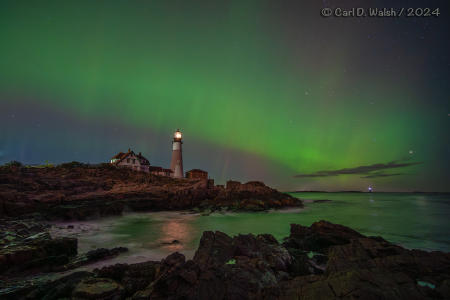 Unusually extreme Northern Lights, this far south, over Portland Head Light on the Maine Coast on October 10, 2024