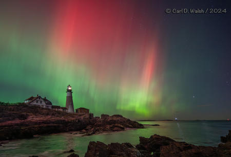 Unusually extreme Northern Lights, this far south, over Portland Head Light on the Maine Coast on October 10, 2024