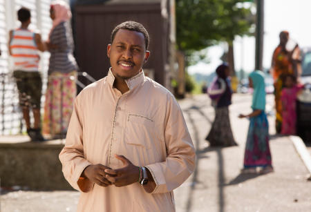 Somali immigrant Osman Bashir, 25, stands in his Lewiston community on Birch Street. Bashir is in the second phase of testing to become a Lewiston police officer.